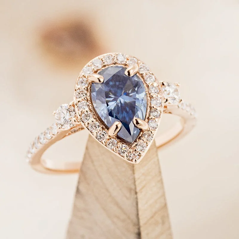 "KB" - PEAR CUT ICY BLUE MOISSANITE ENGAGEMENT RING WITH DIAMOND HALO & ACCENTS